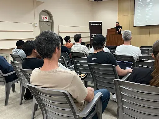 Developers seated in rows watching a HostAfrica presentation at the Clawd and Claws meetup
