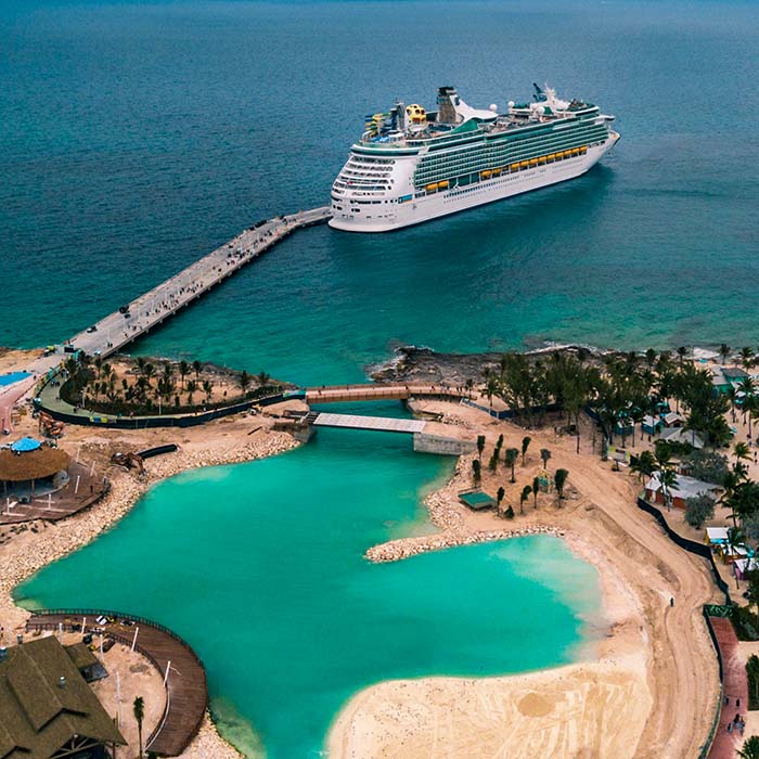 a luxury liner docked next to an island resort